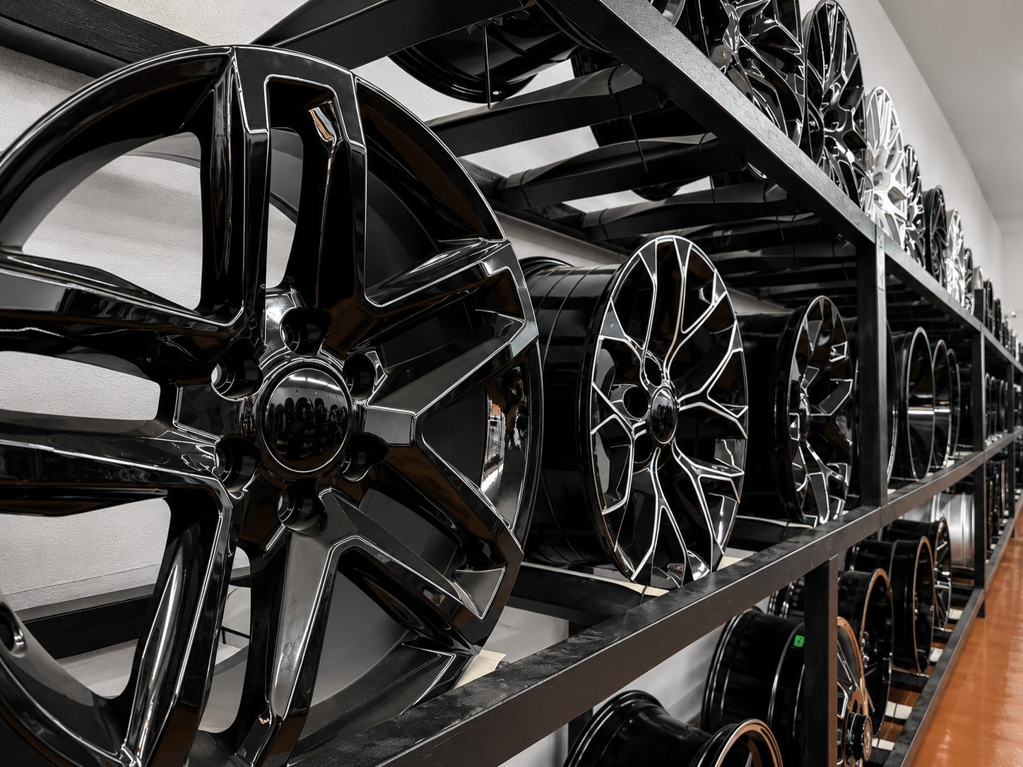 Gloss black and milled wheels racked at Rocket Tires